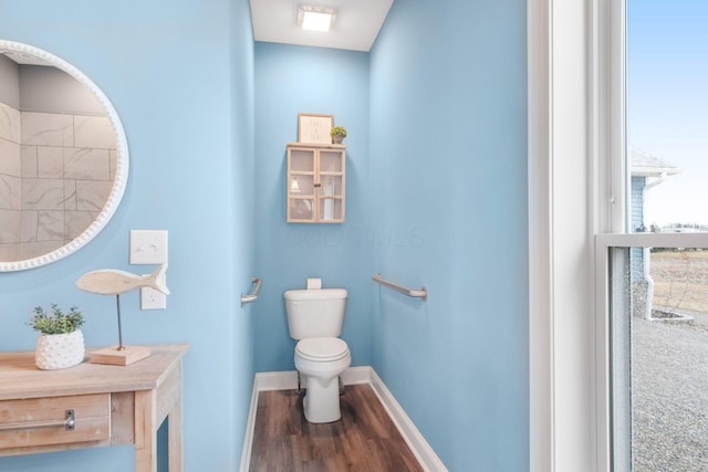 bathroom featuring toilet, baseboards, and wood finished floors