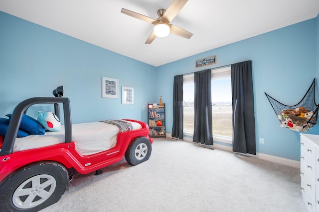 carpeted bedroom featuring ceiling fan and baseboards