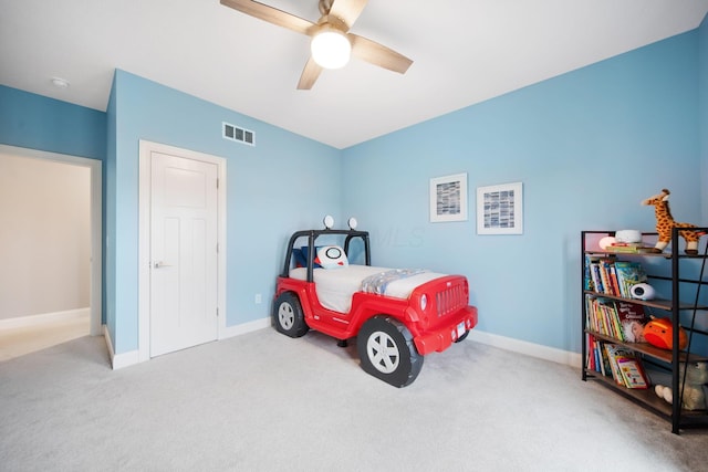 carpeted bedroom with visible vents, ceiling fan, and baseboards