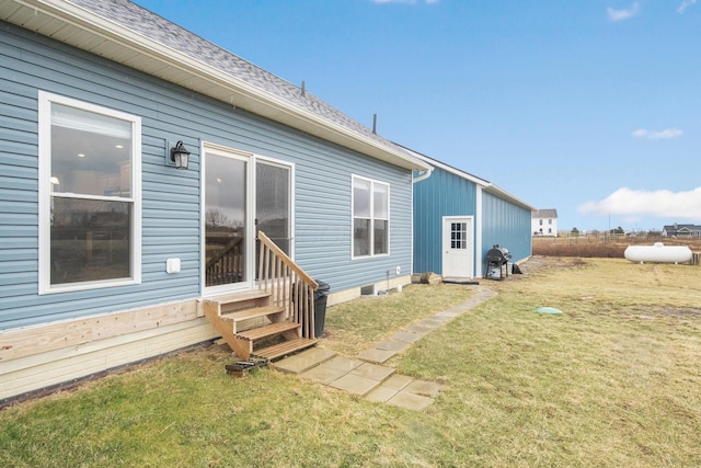 rear view of house with a lawn and entry steps