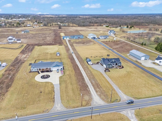 birds eye view of property with a rural view