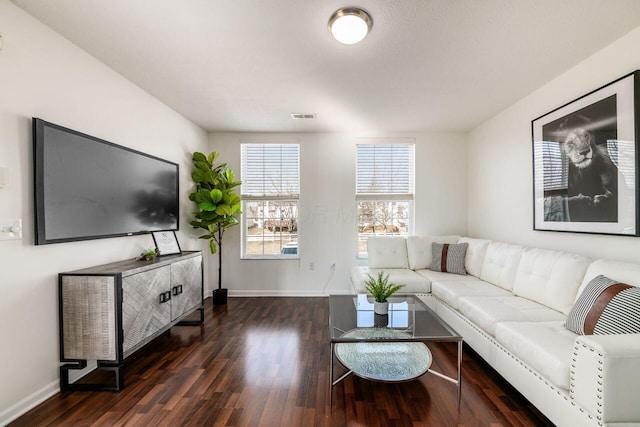 living area featuring visible vents, baseboards, and dark wood-style flooring