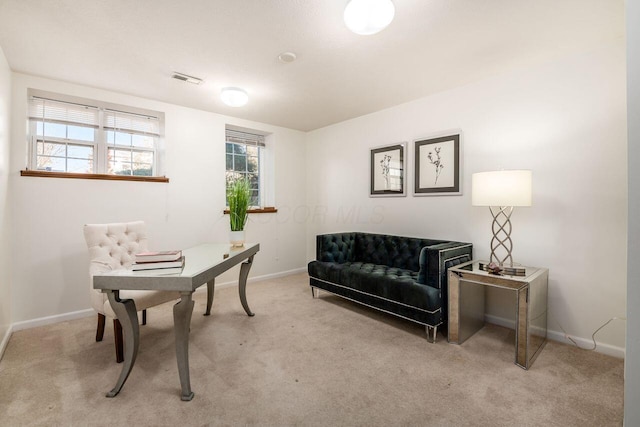 office space featuring visible vents, baseboards, and light colored carpet