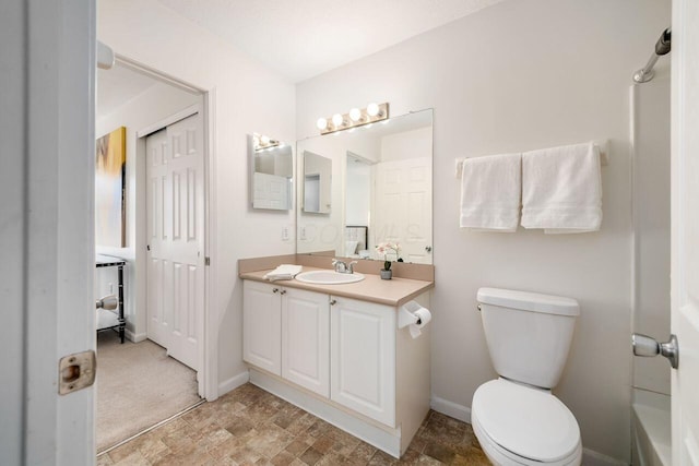 full bath with vanity, toilet, and baseboards