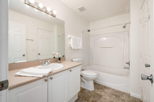 bathroom with visible vents, toilet, vanity, and shower / tub combination