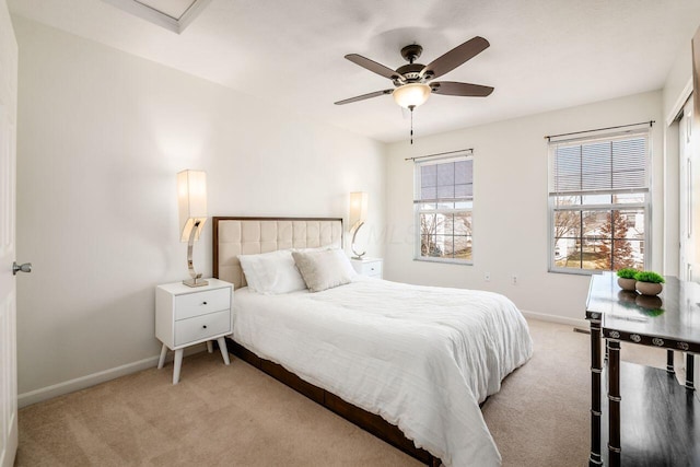 carpeted bedroom with baseboards and ceiling fan