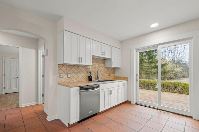 kitchen featuring a sink, white cabinetry, light countertops, dishwasher, and tasteful backsplash