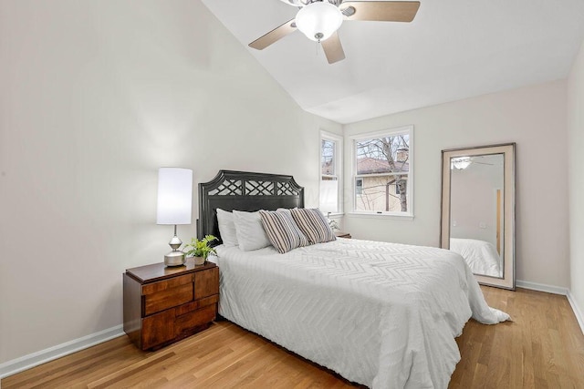 bedroom featuring baseboards, vaulted ceiling, a ceiling fan, and light wood-style floors