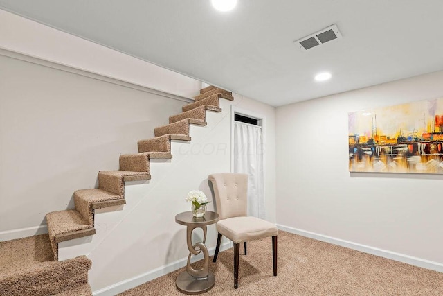 sitting room featuring carpet floors, visible vents, stairway, and baseboards