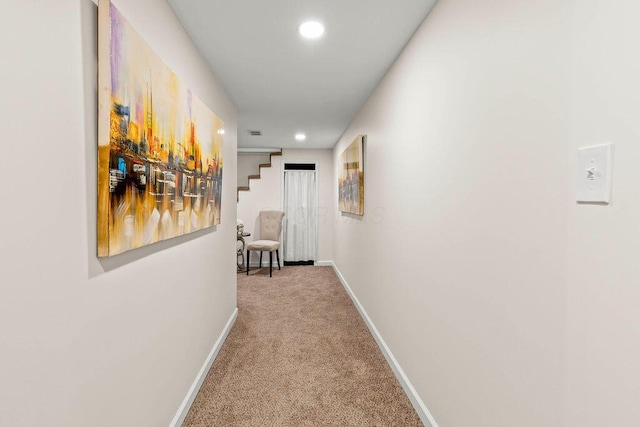 hallway featuring carpet floors, recessed lighting, visible vents, and baseboards