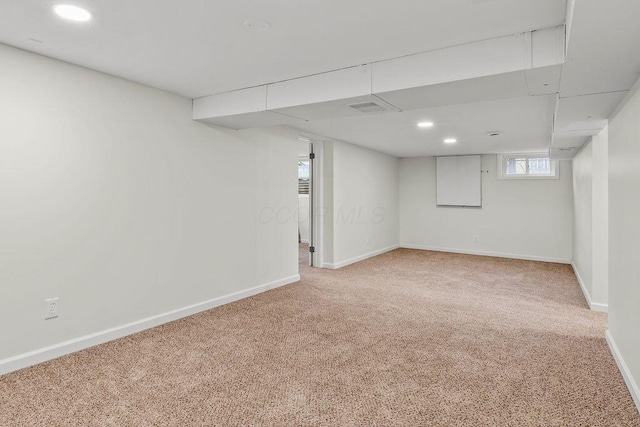 basement featuring recessed lighting, light colored carpet, and baseboards