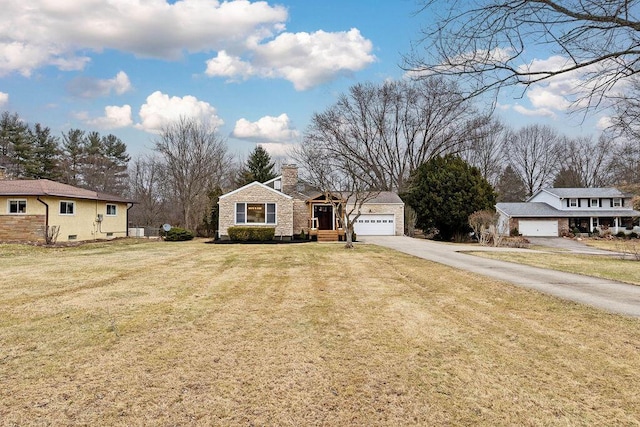 view of front of house featuring a garage, driveway, a front lawn, and a chimney