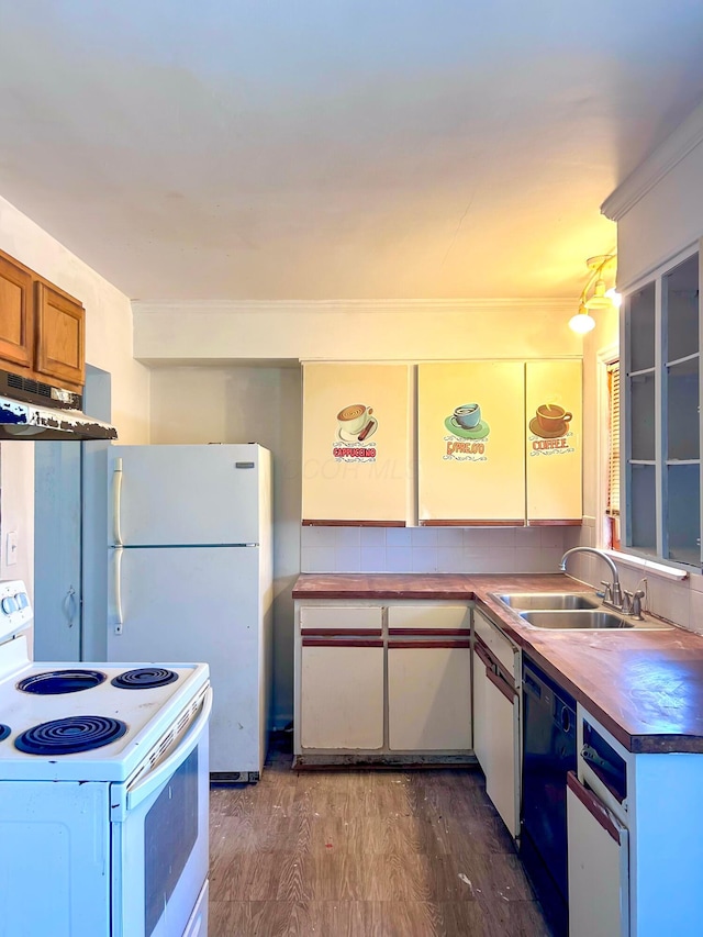 kitchen with under cabinet range hood, white appliances, dark wood-style flooring, a sink, and brown cabinets