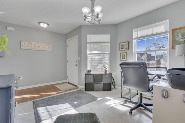 office area with a notable chandelier and baseboards