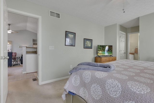 carpeted bedroom featuring a textured ceiling, visible vents, and baseboards