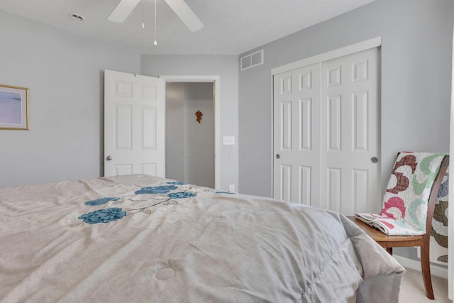 bedroom with a closet, visible vents, and a ceiling fan