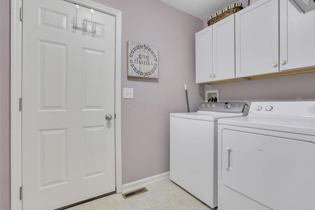 washroom featuring light tile patterned flooring, visible vents, baseboards, independent washer and dryer, and cabinet space