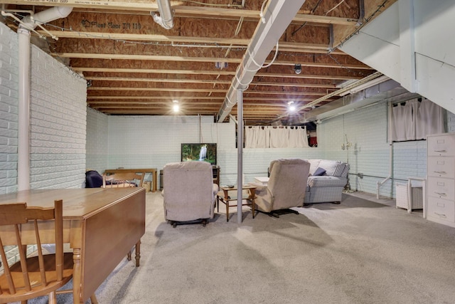 interior space with carpet floors and brick wall