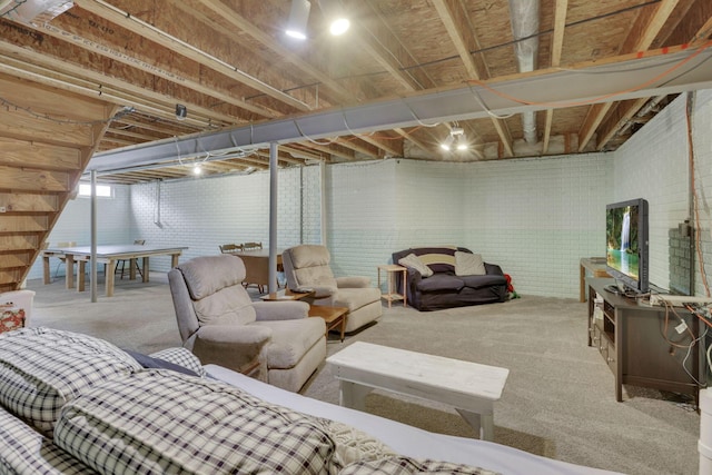 unfinished basement featuring brick wall and carpet floors