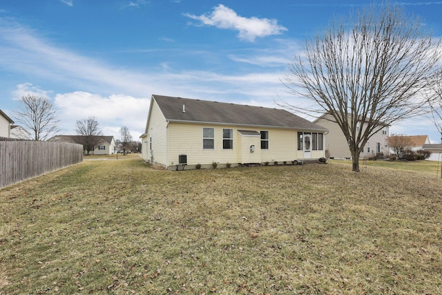 exterior space with a yard, central AC unit, and fence