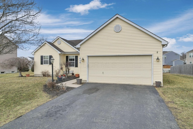 ranch-style house featuring a garage, driveway, a front lawn, and fence