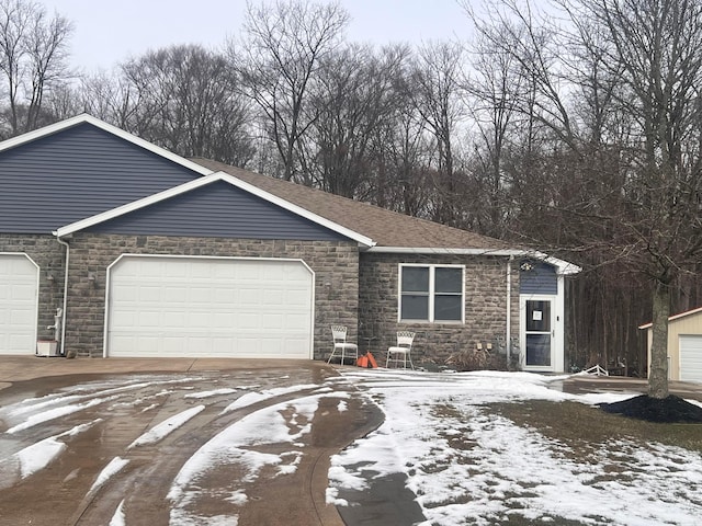 view of front facade featuring a garage and a shingled roof