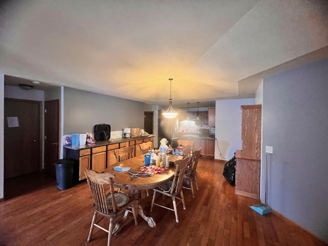 dining room featuring baseboards and dark wood finished floors