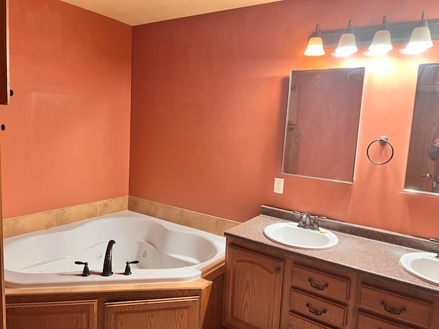 full bath featuring a sink, a whirlpool tub, and double vanity