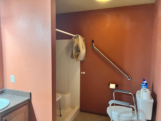 full bathroom with baseboards, toilet, tile patterned floors, vanity, and a shower stall