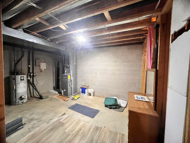 unfinished basement featuring heating unit and electric water heater