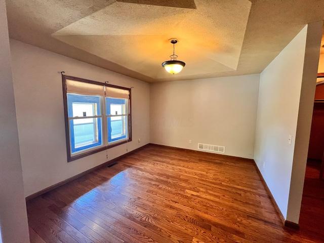 1396 Spring Village Dr, Mansfield, OH 44906 - spare room featuring wood finished floors, a textured ceiling, and baseboards