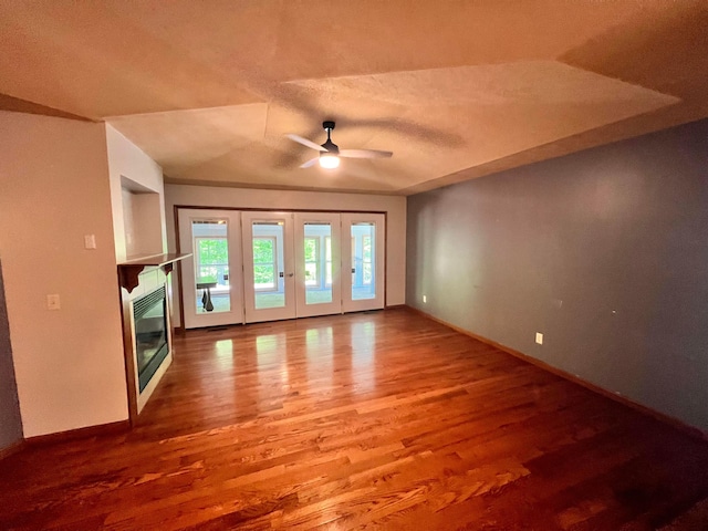 1396 Spring Village Dr, Mansfield, OH 44906 - unfurnished living room featuring ceiling fan, wood finished floors, baseboards, a glass covered fireplace, and a textured ceiling