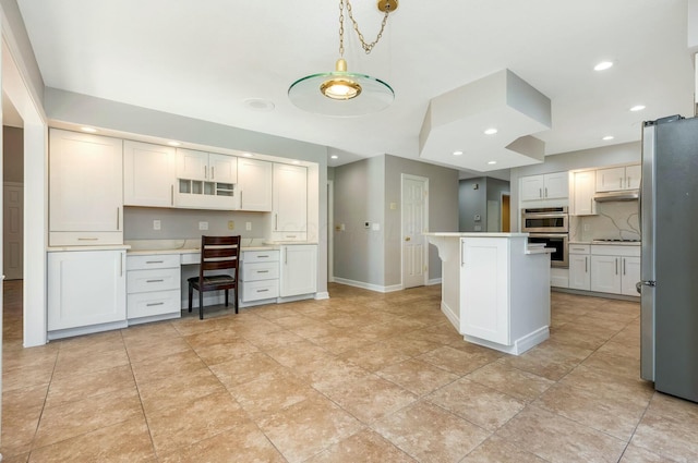 kitchen featuring built in study area, light countertops, decorative backsplash, recessed lighting, and stainless steel appliances