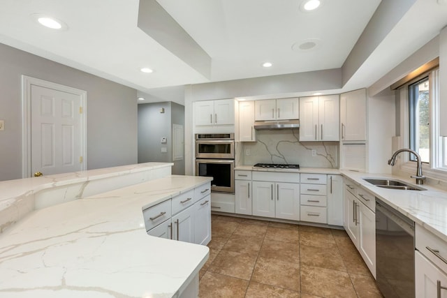 kitchen featuring recessed lighting, a sink, decorative backsplash, under cabinet range hood, and appliances with stainless steel finishes