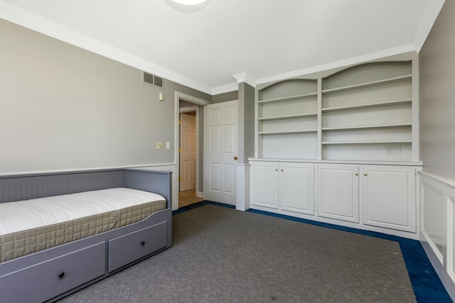 unfurnished bedroom with dark colored carpet, visible vents, a wainscoted wall, and crown molding