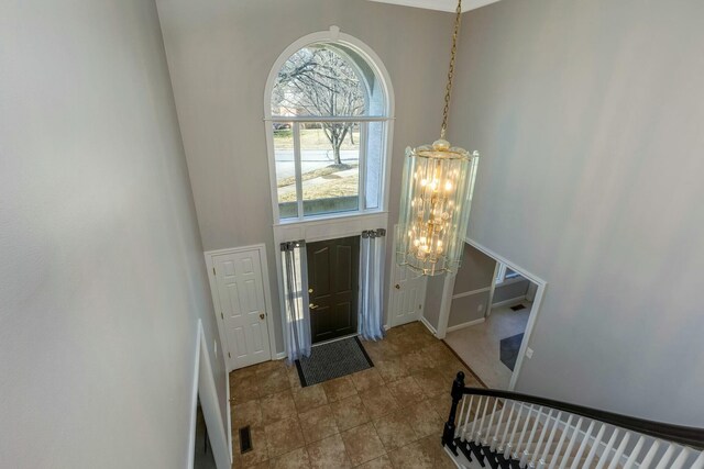 entryway with a notable chandelier and a high ceiling