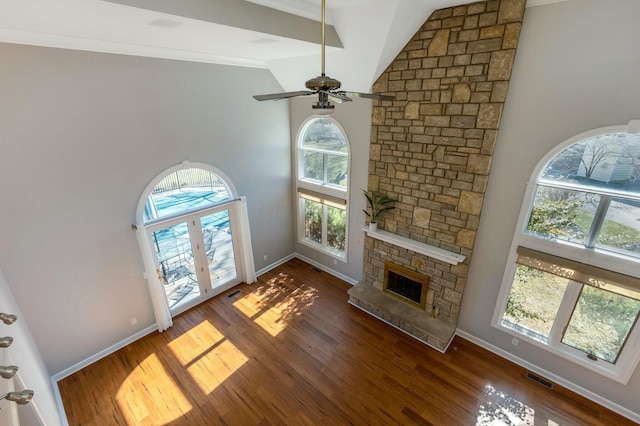 living area featuring a fireplace, high vaulted ceiling, ceiling fan, and wood finished floors