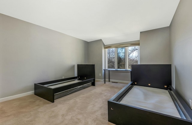 carpeted bedroom with baseboards