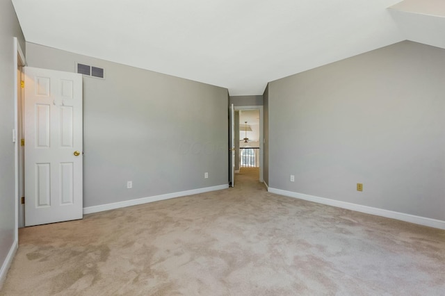 unfurnished bedroom featuring visible vents, carpet floors, lofted ceiling, and baseboards