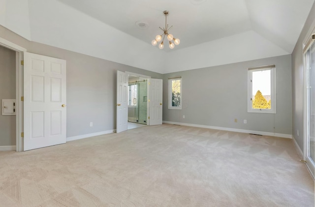 unfurnished bedroom with vaulted ceiling, light colored carpet, and baseboards