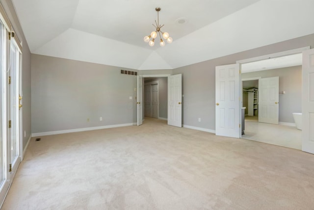 unfurnished bedroom featuring visible vents, carpet flooring, baseboards, a chandelier, and vaulted ceiling