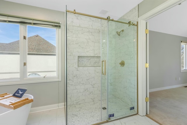 full bath featuring baseboards, marble finish floor, and a wealth of natural light