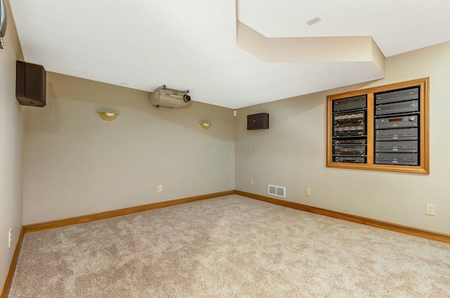 carpeted empty room featuring visible vents and baseboards