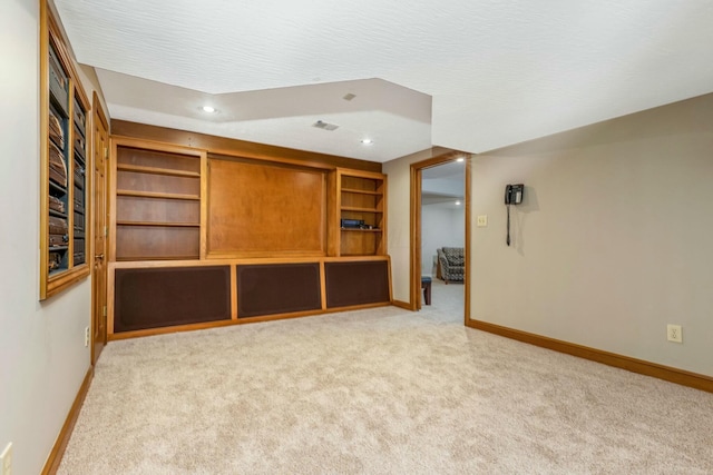 spare room featuring recessed lighting, light colored carpet, baseboards, and a textured ceiling