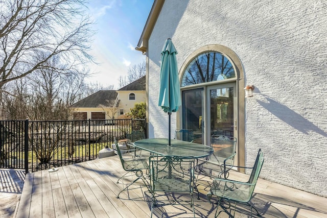 wooden deck featuring outdoor dining area