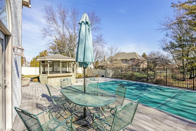 view of pool with a gazebo, fence, and a wooden deck