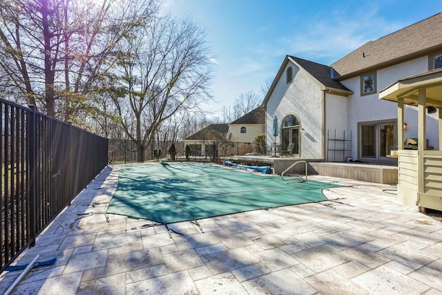 view of swimming pool featuring a patio area, fence, and a fenced in pool