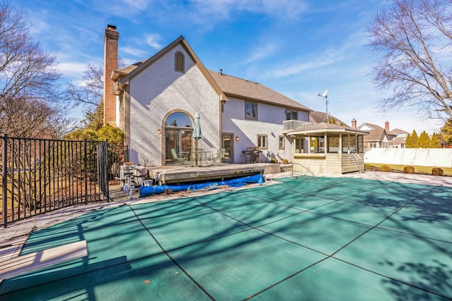 view of pool featuring a wooden deck and fence