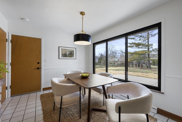 dining room featuring light tile patterned flooring and baseboards