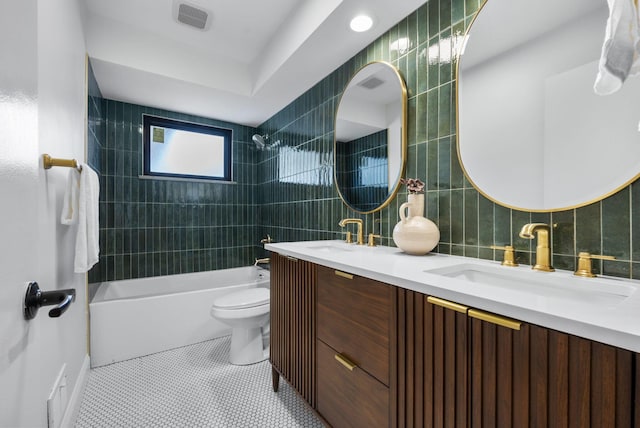 full bathroom featuring tile patterned flooring, a sink, visible vents, bathing tub / shower combination, and tile walls